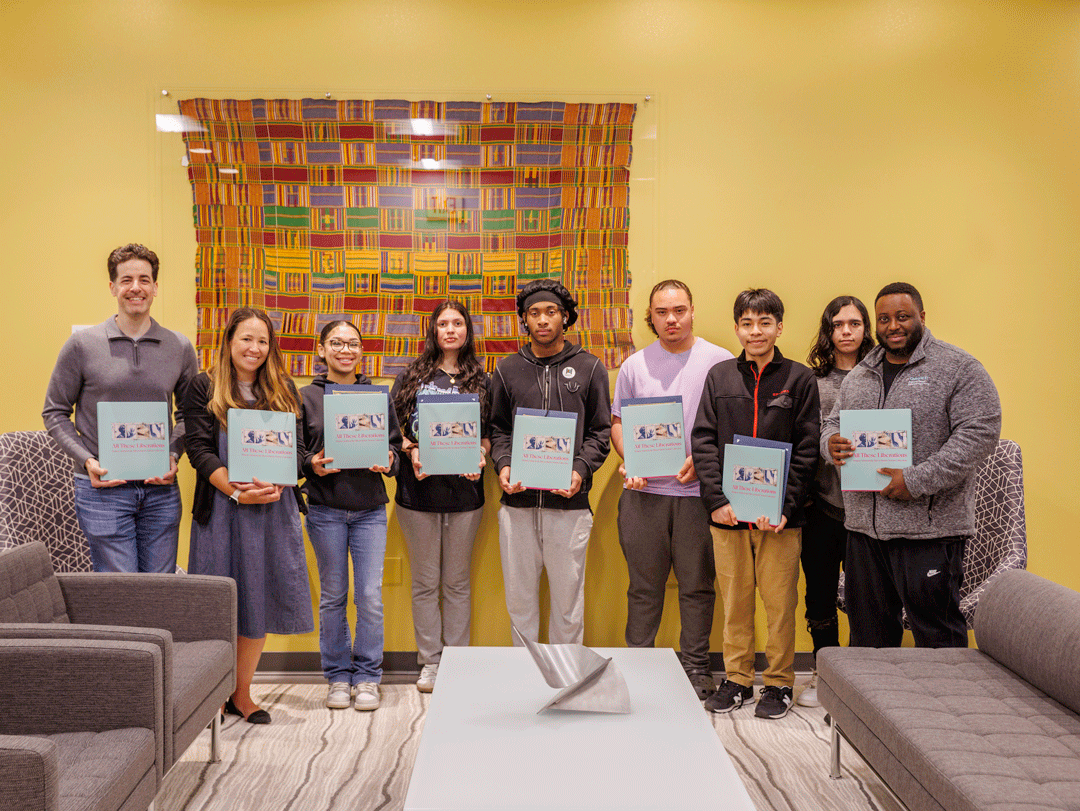 Student artists with book