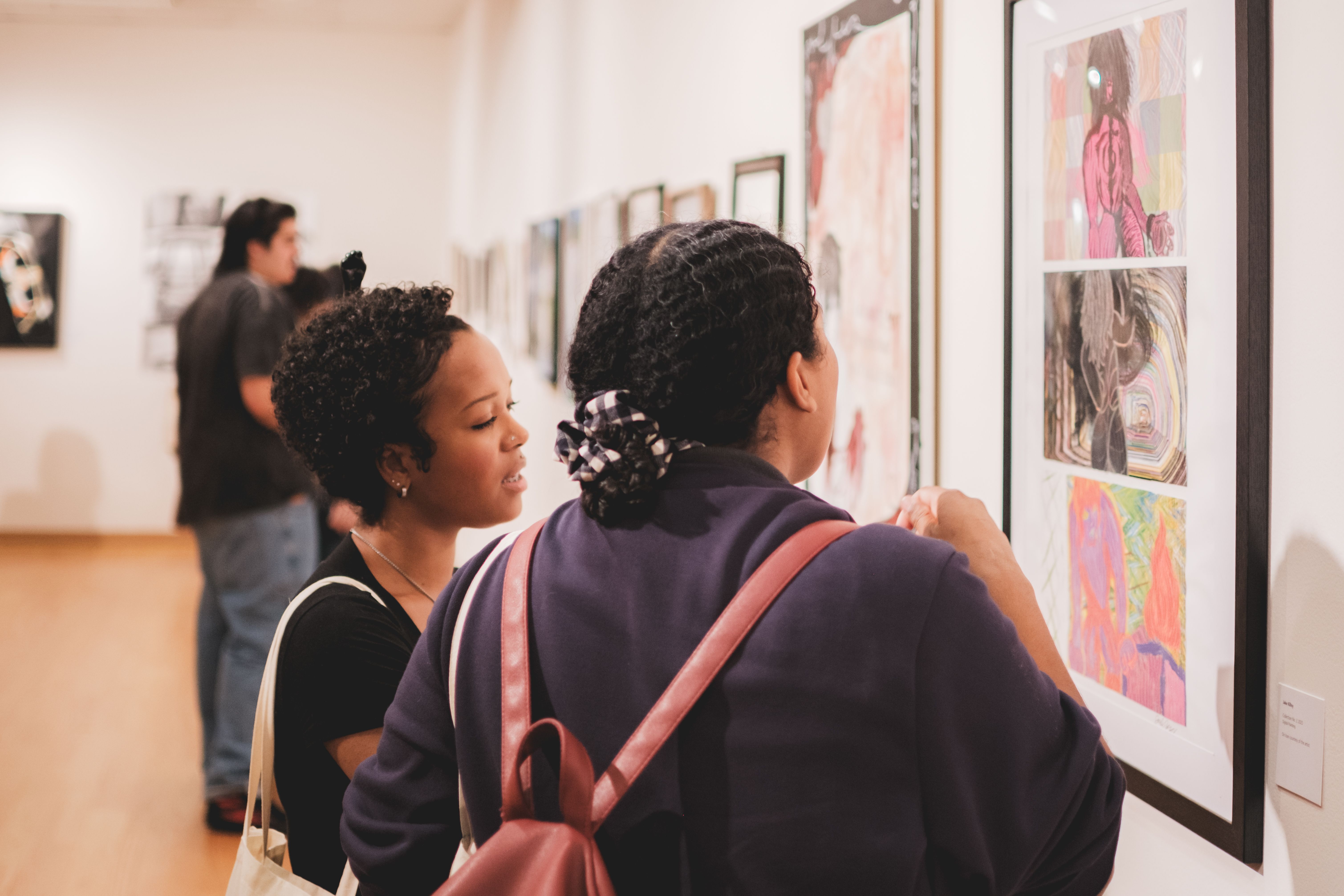 Two students looking at artwork