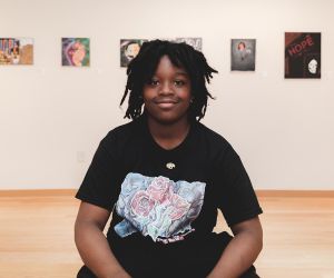 Student artist sitting in gallery 