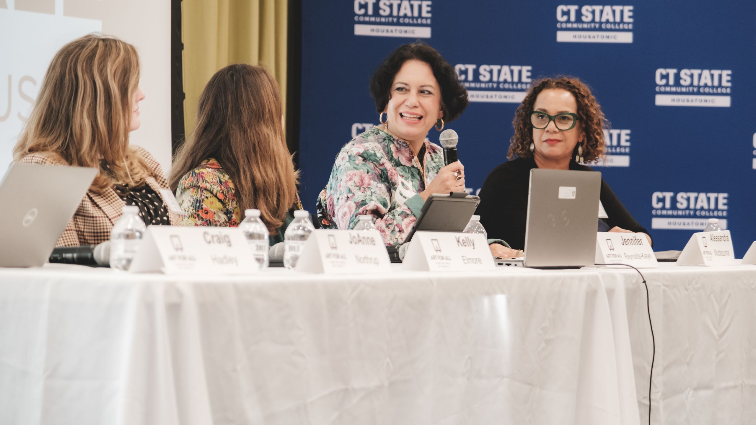 Four panelists at a table discussing Art for All