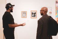 Two students looking at artwork