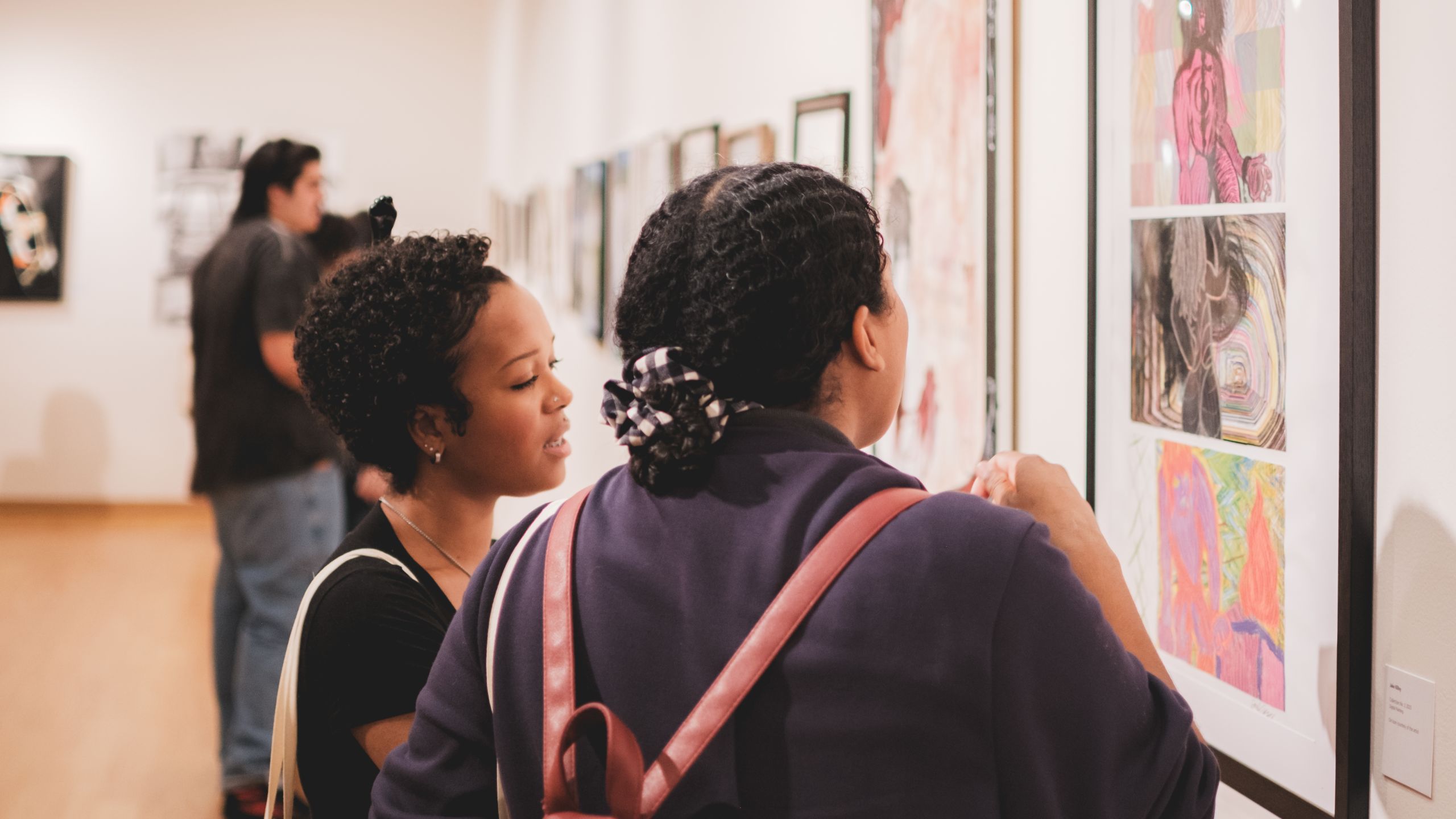 Two students looking at artwork