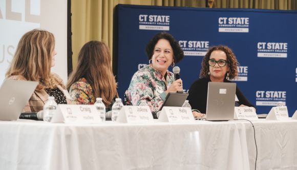 Four panelists at a table discussing Art for All