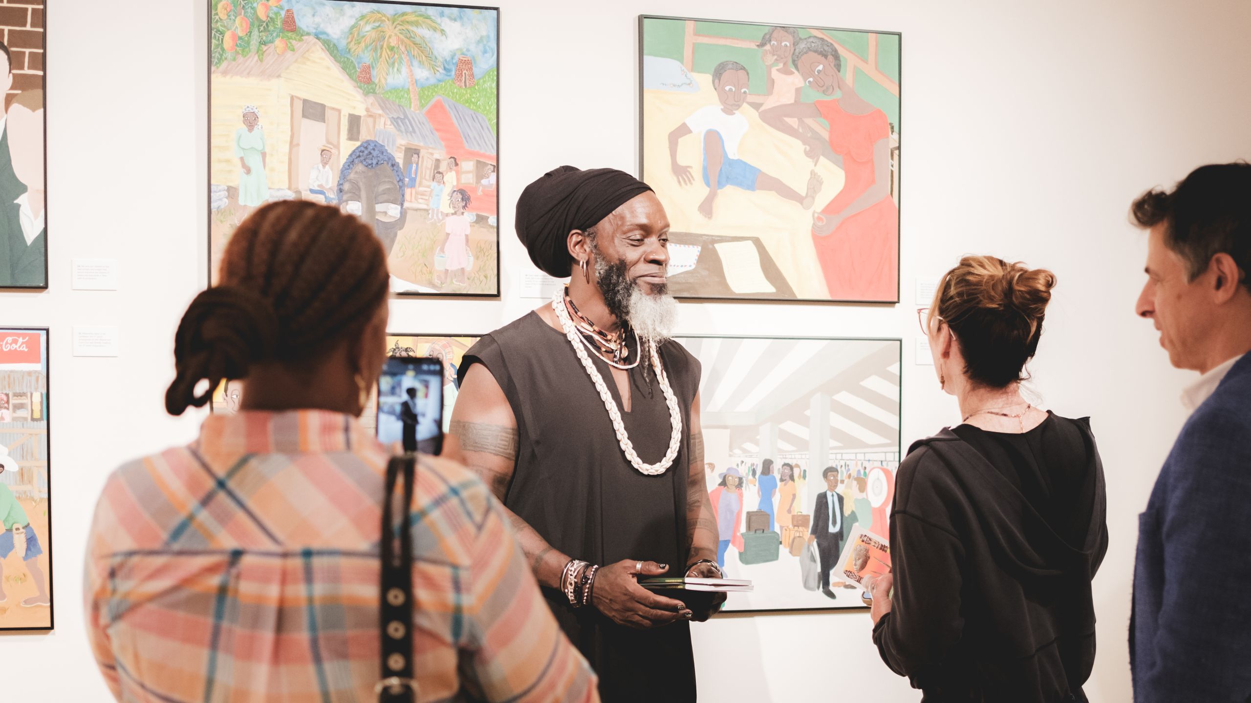 Iyaba Ibo Mandingo speaking with visitors in exhibition. Photography by Brandon Smith, Whiskey & Oxfords