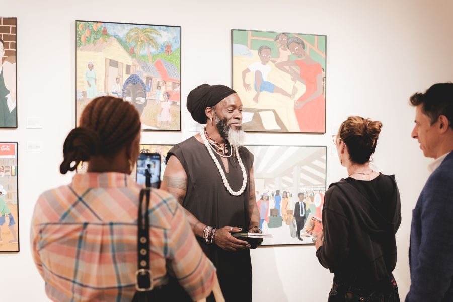 Iyaba Ibo Mandingo speaking with visitors in exhibition. Photography by Brandon Smith, Whiskey & Oxfords