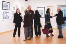 Group of attendees in the front gallery of "Ink and Impression: 110 Years of SAGA. Image credit: Brandon Smith, Whiskey & Oxfords.