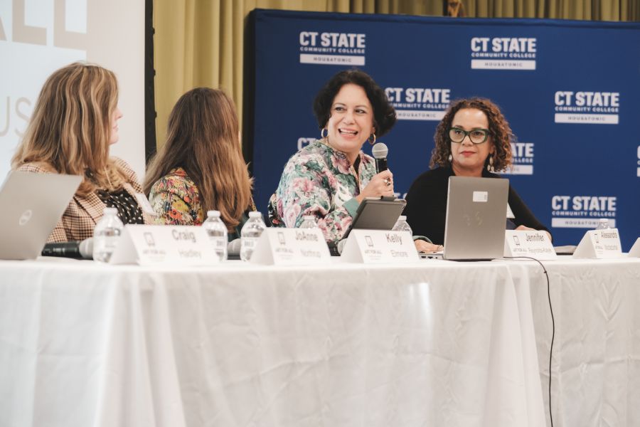 Four panelists at a table discussing Art for All